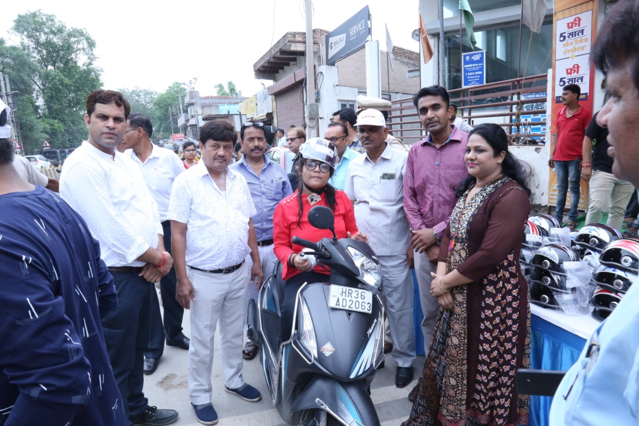 Road Safety Awareness & Helmet Distribution Camp for Ladies.