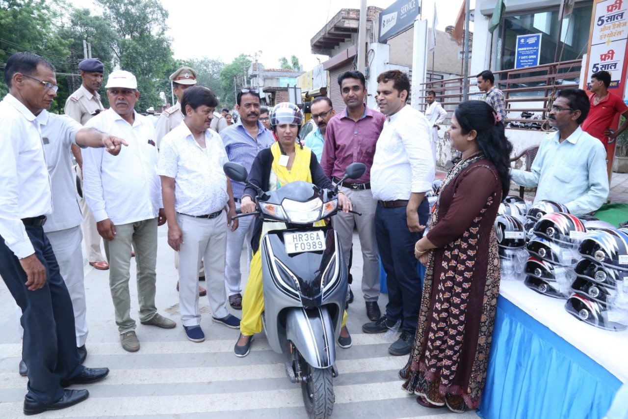 Road Safety Awareness & Helmet Distribution Camp for Ladies.