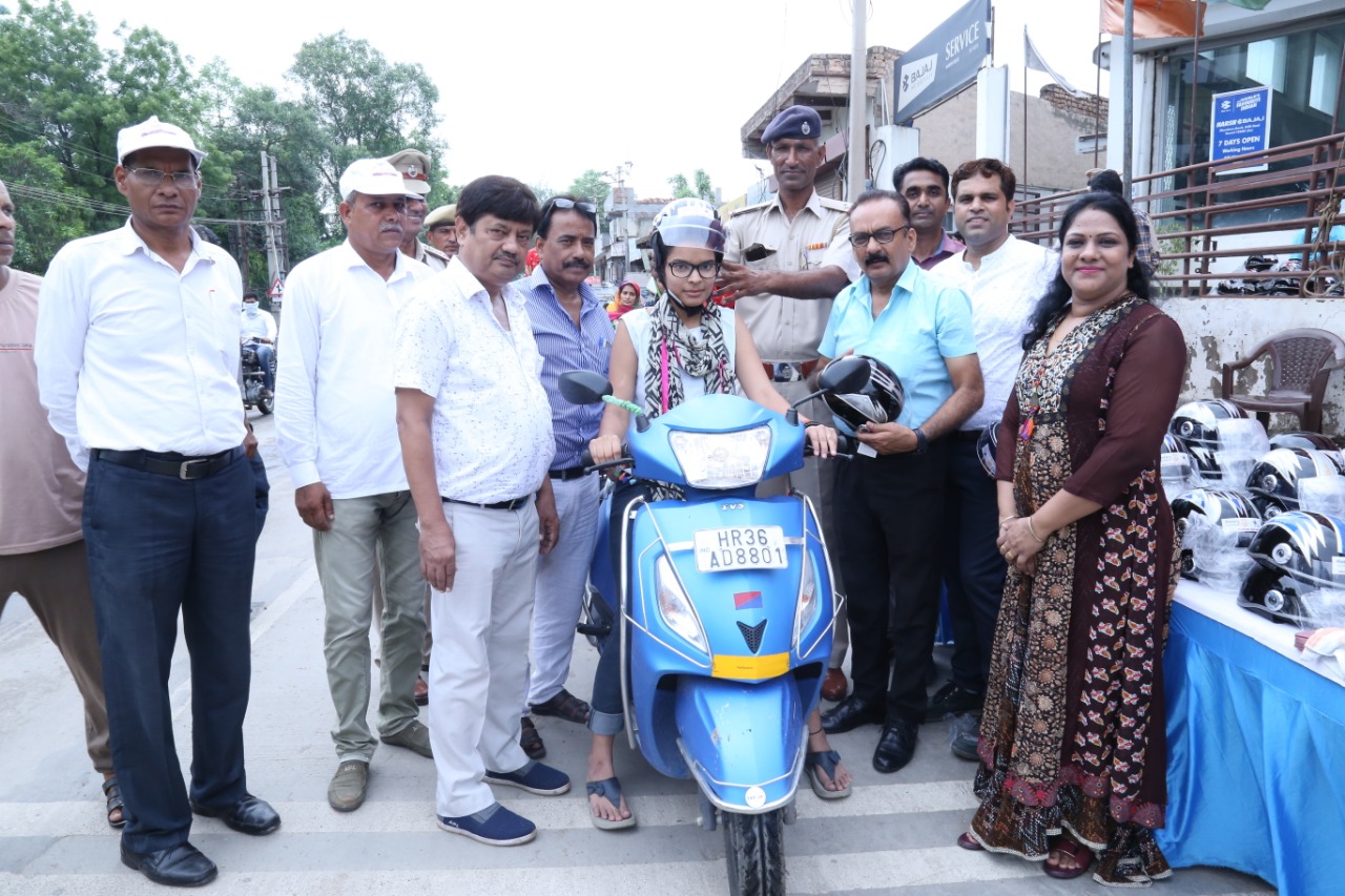 Road Safety Awareness & Helmet Distribution Camp for Ladies.