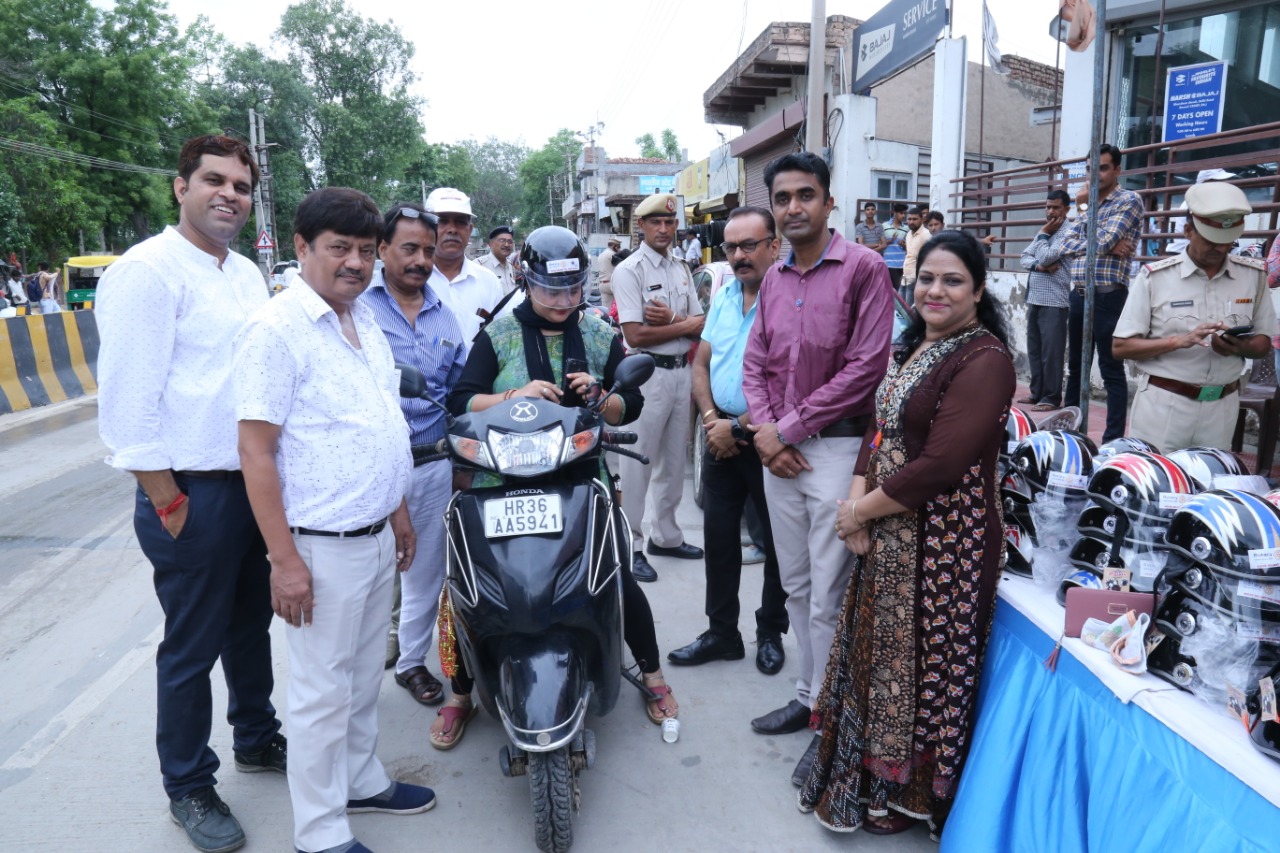 Road Safety Awareness & Helmet Distribution Camp for Ladies.