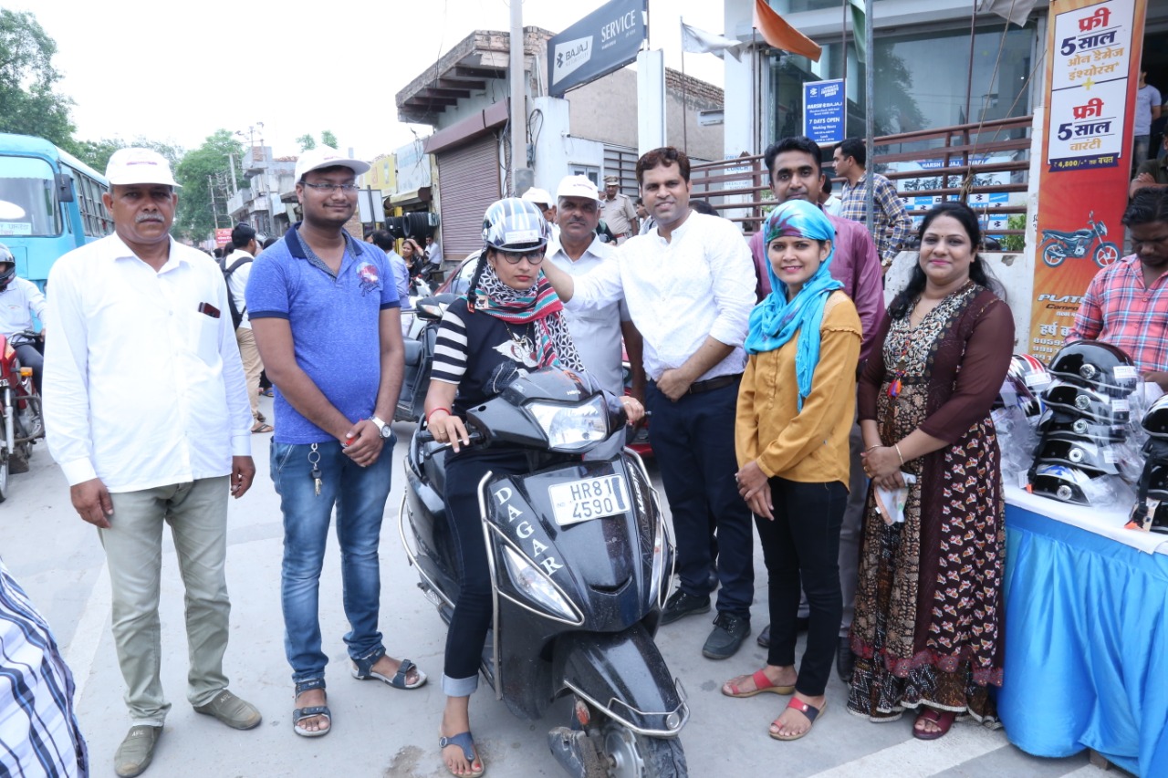 Road Safety Awareness & Helmet Distribution Camp for Ladies.