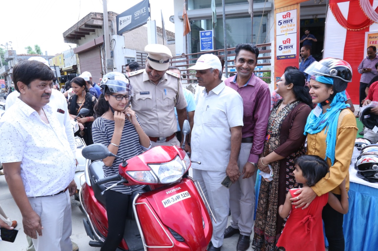 Road Safety Awareness & Helmet Distribution Camp for Ladies.