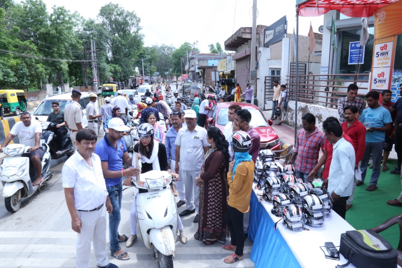 Road Safety Awareness & Helmet Distribution Camp for Ladies.