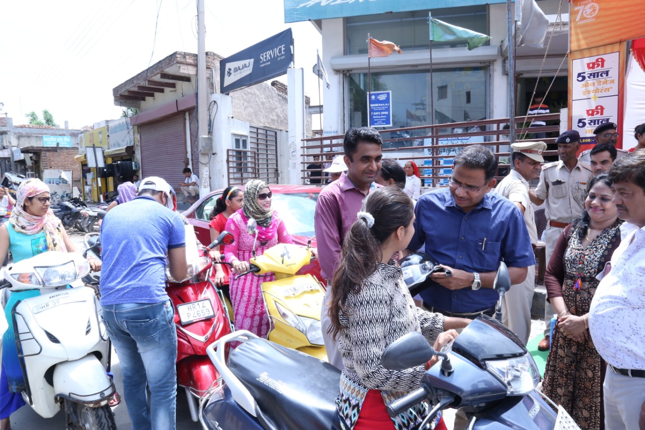 Road Safety Awareness & Helmet Distribution Camp for Ladies.