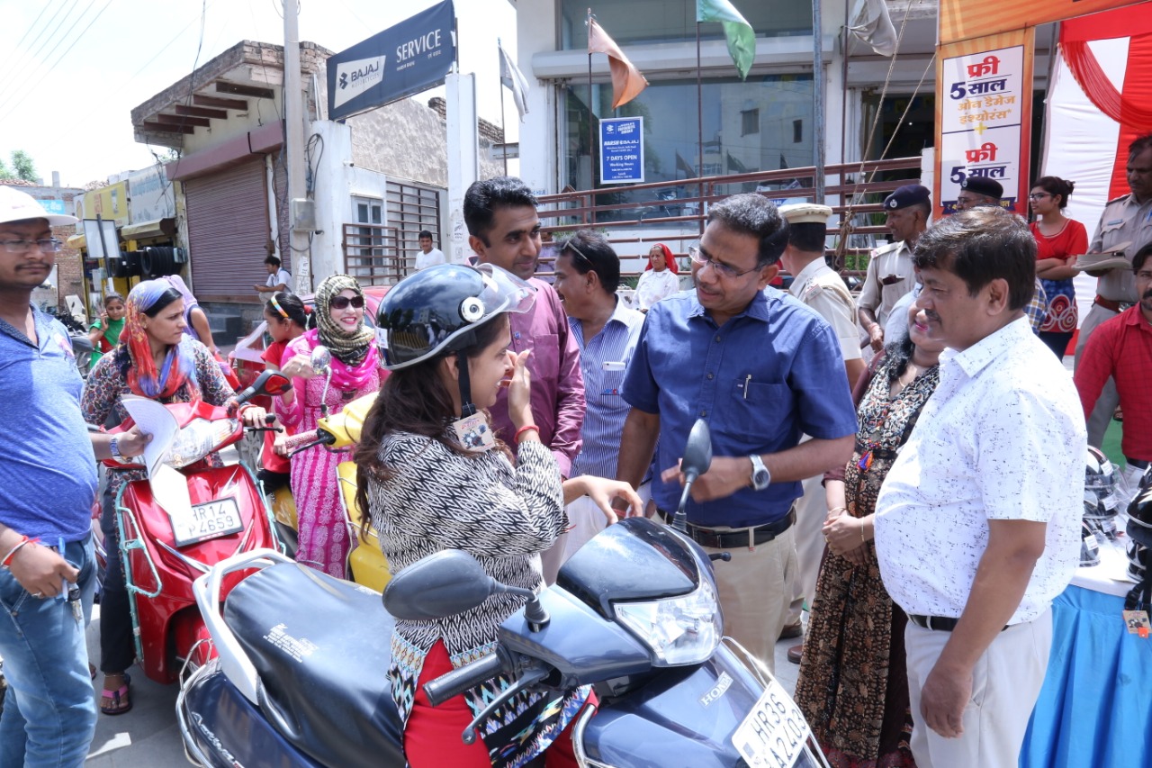 Road Safety Awareness & Helmet Distribution Camp for Ladies.