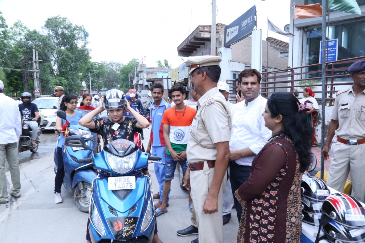 Road Safety Awareness & Helmet Distribution Camp for Ladies.