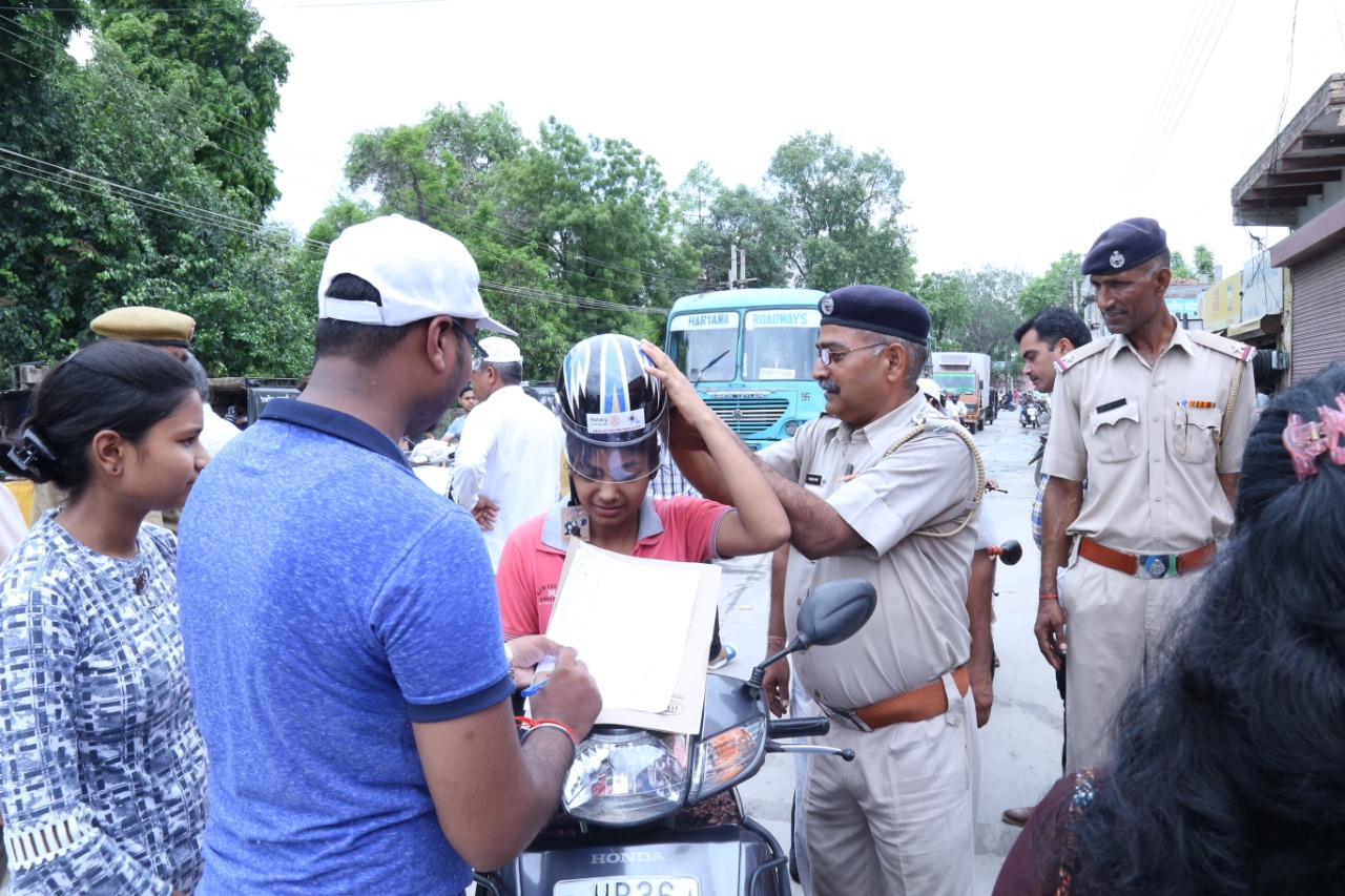 Road Safety Awareness & Helmet Distribution Camp for Ladies.