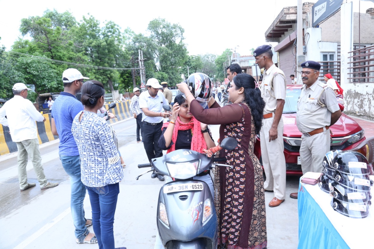 Road Safety Awareness & Helmet Distribution Camp for Ladies.