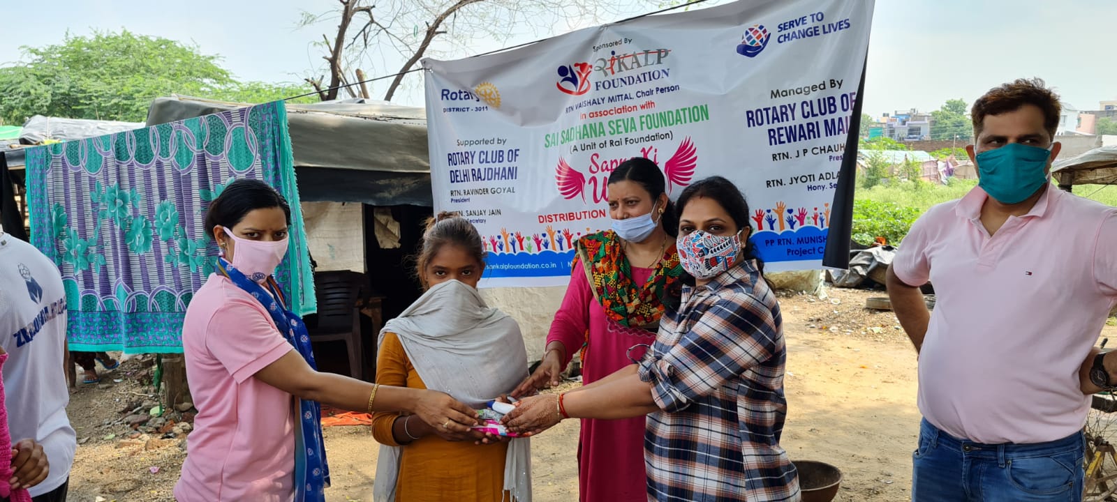 Distribution of Sanitary Napkins , Face wash & Coronil kit